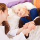 Fotolia 46721679 - Young doctor holds the elderly woman hands © Ocskay Bence